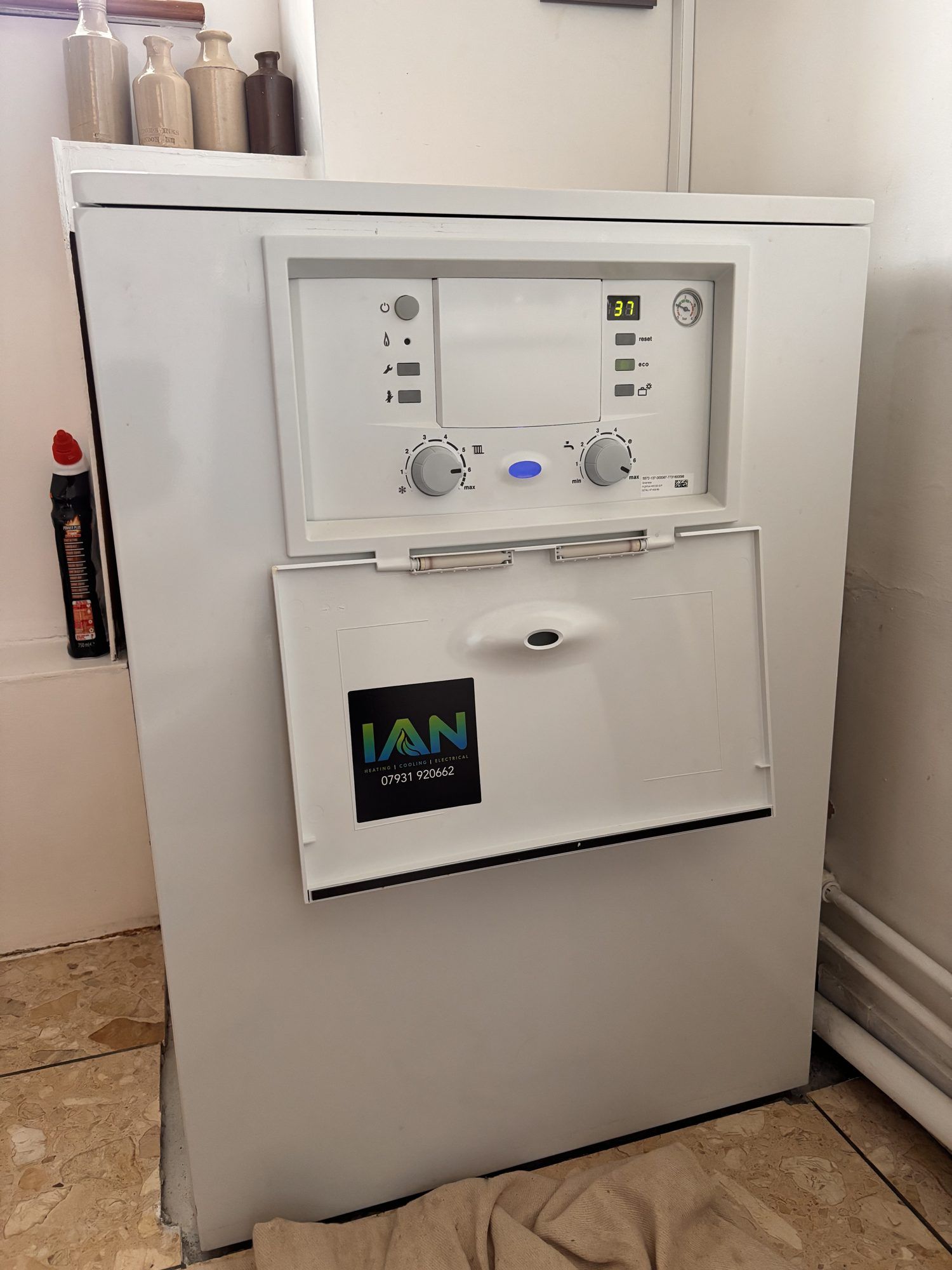 A white floor-standing Worcester Bosch Highflow 440 gas boiler with its control panel showing 37 degrees
